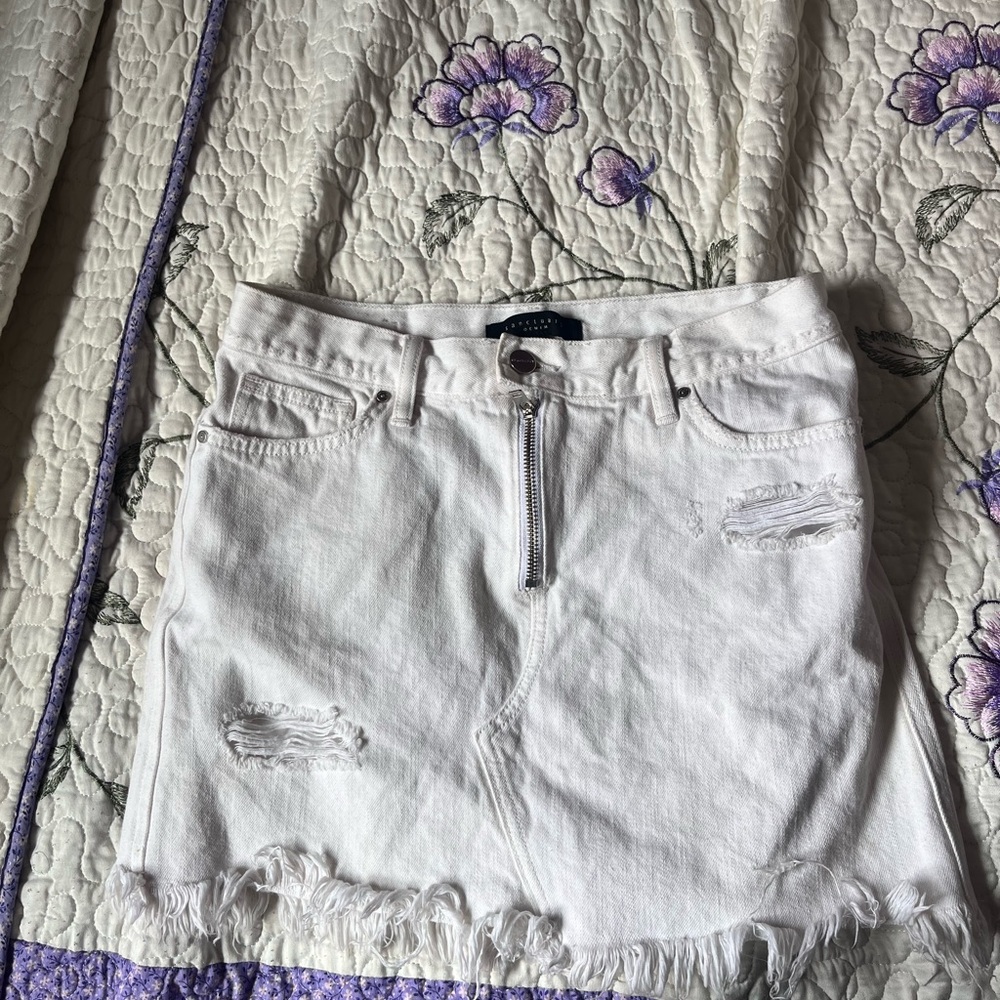 White distressed denim shorts with zip up front